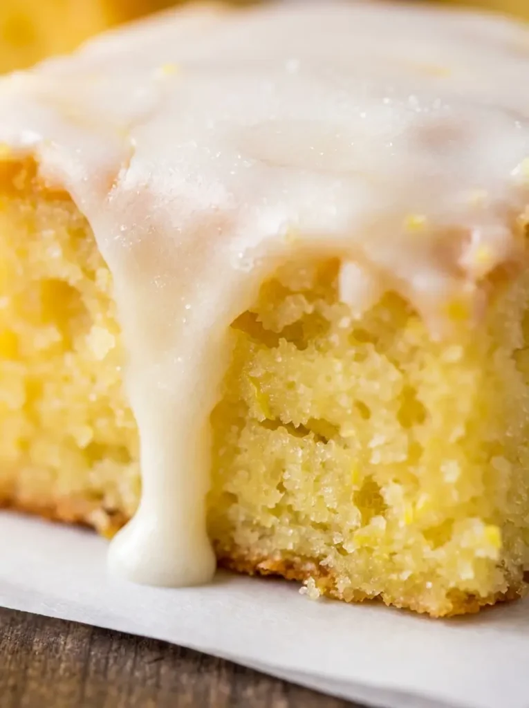Lemon Brownies Recipe - A clean, organized overhead shot of ingredients for lemon brownies laid out on a marble countertop: fresh bright yellow lemons, a ceramic bowl of all-purpose flour, granulated sugar, sticks of butter, and eggs. A wooden cutting board is visible in the background with a zester. Natural morning light, warm tones. (3:4 ratio)