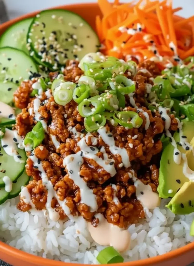 High-Protein Ground Turkey Rice Bowls A top-down ingredients shot on a rustic wooden cutting board placed on a marble surface. Visible are a bunch of bright green onions, a whole ginger root, sliced cucumber rounds, and a pile of vibrant shredded carrots. A minimalist white ceramic bowl of raw ground turkey is nearby. Clean and tidy presentation with natural morning light.