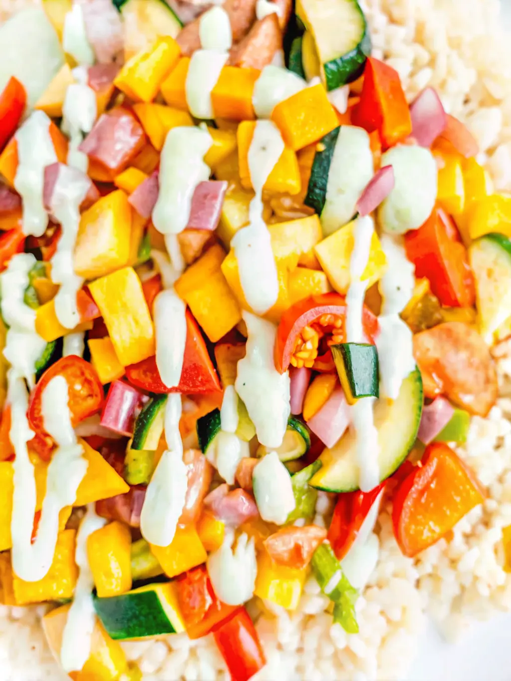 A minimalist white ceramic bowl filled with raw cashews soaking in water, alongside freshly chopped green onions, a garlic clove, and a lemon half, all arranged artfully on a light wooden cutting board on a white marble countertop under soft natural light. No hands visible.