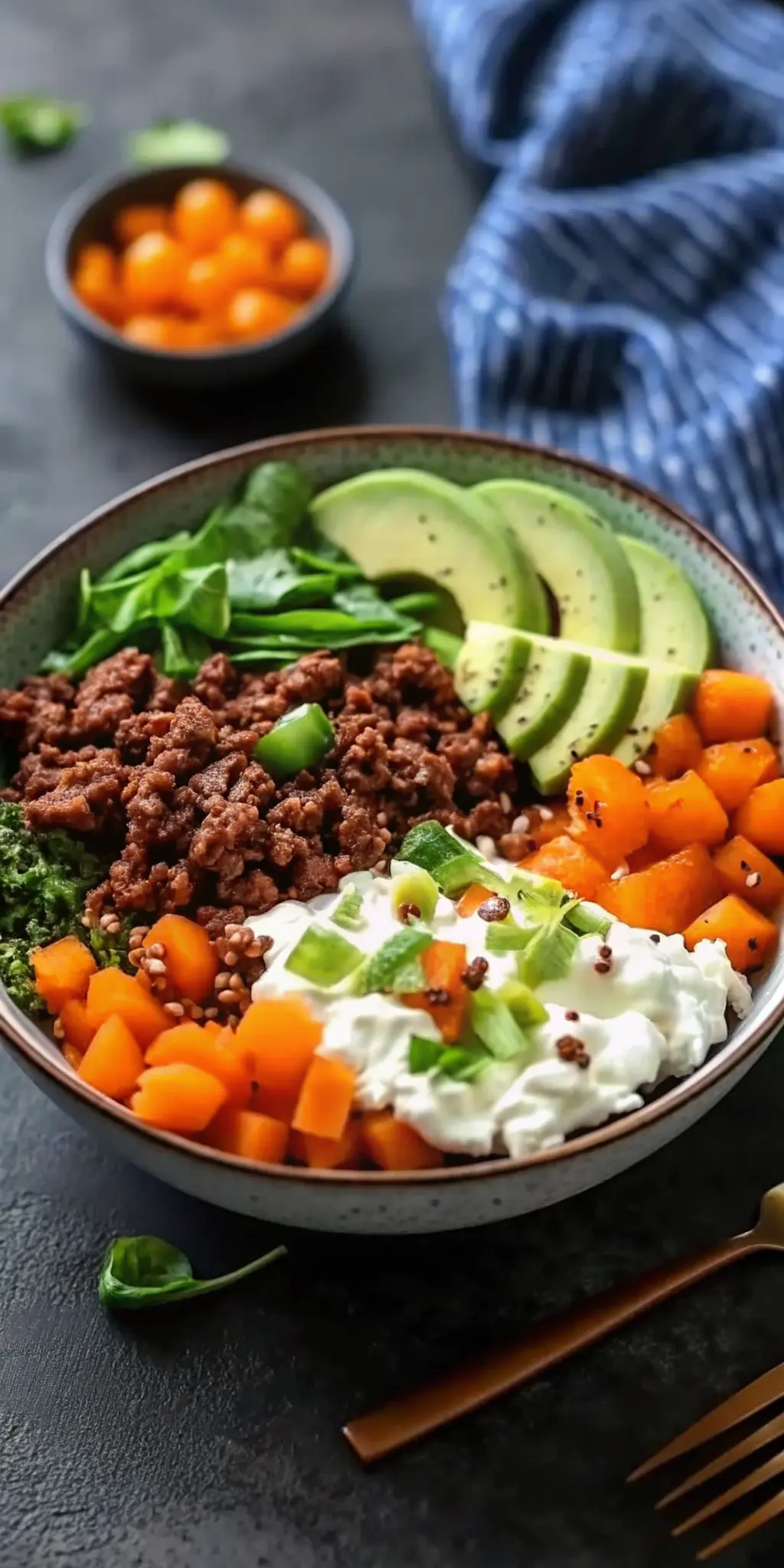 A top-down shot of the fully assembled Savory Ground Beef Hot Honey Bowl, focusing on the textured components: the browned ground beef, soft orange squash, creamy avocado slices, and particularly highlighting the luscious creamy white ricotta cheese with the golden hot honey pooling and drizzling over it. Garnished with green onions and cilantro, presented in a ceramic bowl on a marble countertop, soft morning light, warm tones. (3:4 ratio), NO HANDS OR PEOPLE.