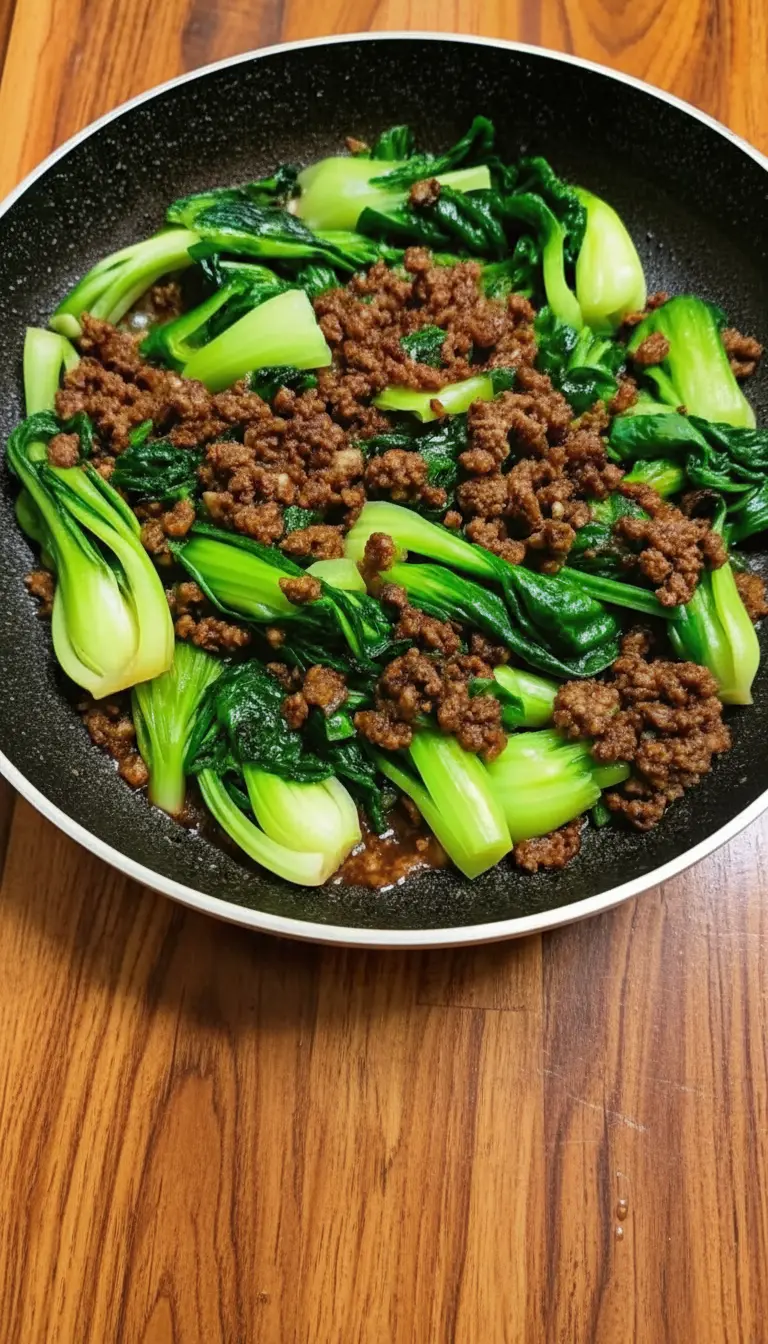 A macro texture shot of the finished dish. Focus on a single piece of bok choy showing the gradient from white stem to green leaf, glistening with the savory brown glaze and specks of ground beef. The texture looks juicy and crisp-tender. Warm tones and high detail.