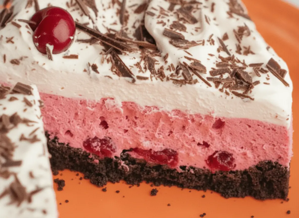 A hero shot of a whole Chocolate Cranberry Cream Pie in a white ceramic pie dish, sitting on a marble countertop. The pie features a dark chocolate cookie crust, a thick layer of vibrant pink cranberry cream, topped with a heavy layer of swooped whipped cream and generous dark chocolate shavings. Soft morning light from an east window creates gentle shadows. Fresh mint sprigs and a few loose cranberries are scattered artistically on the marble nearby. 4:3 aspect ratio.